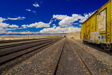 Obraz premium Old rusted freight train on railroad tracks.