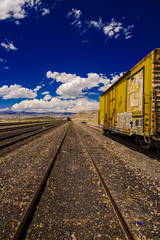 Fototapeta na wymiar Old rusted freight train on railroad tracks.
