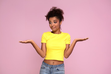 Excited afro girl posing on pink.