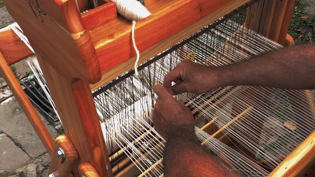 Weaver hands closeup working on the old loom, etara, bulgaria