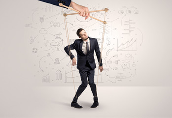 Little businessman controlled from above like a puppet concept
