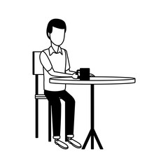 Man drinking coffee on table in black and white