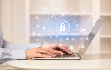 Business woman below chest working on laptop in a cozy homey environment with secured connection concept
