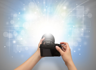 Naked hand taking picture with digital camera and glowing flash concept
