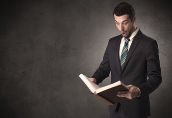 Businessman holding a book in his hand.