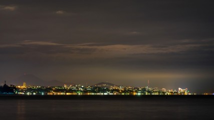 Naklejka na ściany i meble Night view of Black Sea with Sochi on background
