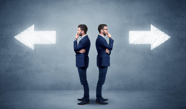 Young conflicted businessman choosing between two directions 