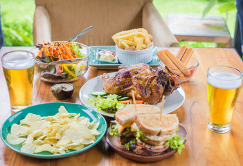  Beer. Dining Concept,With Chicken roasting,salad,French fries on wooden table