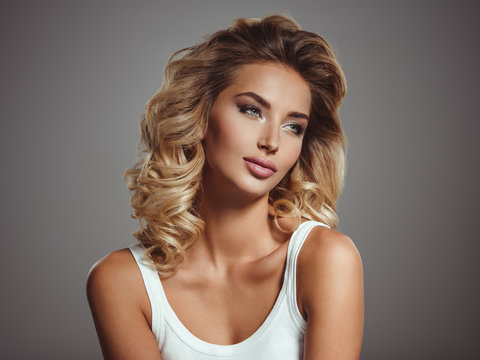 Photo of a beautiful young blond girl with curly hair