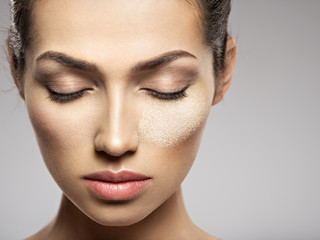 dry cosmetic makeup powder is on the female face. © Valua Vitaly