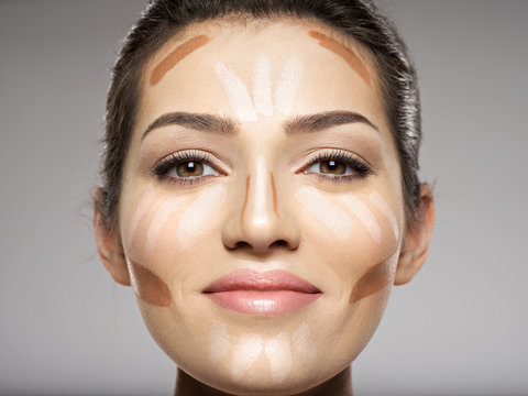 Cosmetic makeup tonal foundation is on woman's face.