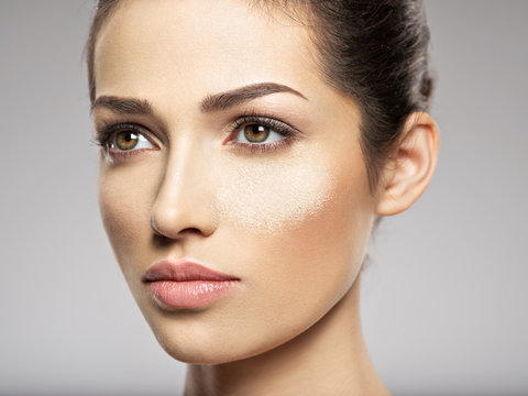 dry cosmetic makeup powder is on the female face.