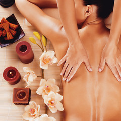 Masseur doing massage on woman back in spa salon