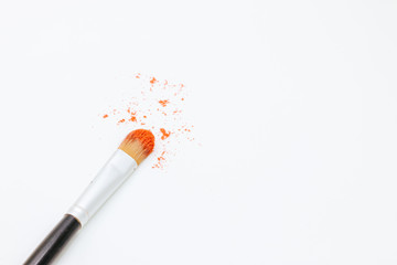 eye shadow in red color and makeup brush isolated on white background