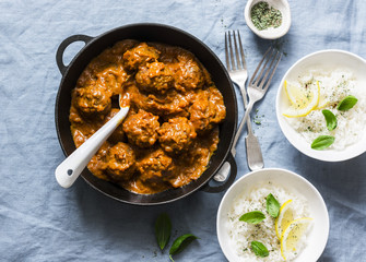 Lentils meatballs in curry sauce and rice - served vegetarian lunch in Indian style. Healthy eating concept. Top view, flat lay