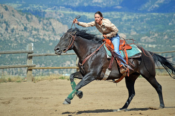Cowgirl Looks at Stop Clock While Galloping