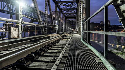 Fototapeta premium Pattullo Bridge, Surrey, British Columbia, Canada. Long exposure of the bridge over the water.