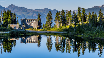 Pristine lodge mirroring in a lake at Mount Baker, Washington - USA.