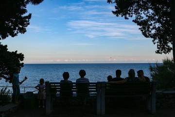 People’s silhouette by the sea