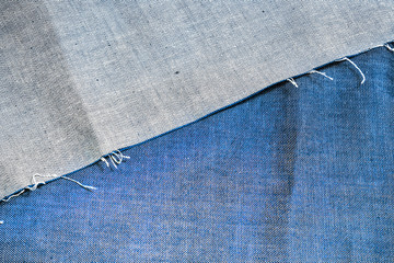 Denim Jeans background. Cut and ripped blue denim fabric