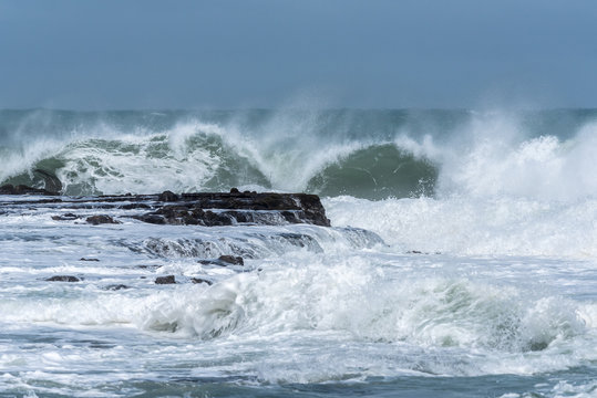 Waves crashing into the rocky headland between Porpoise Bay and Curio Bay on the Catlins coast, Otago, New Zealand. © Steve