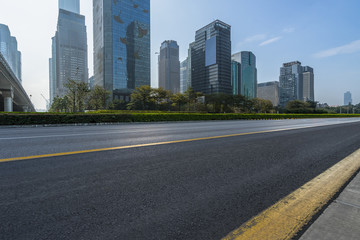 Fototapeta na wymiar empty urban road with modern city skyline in china