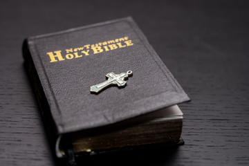 The Bible Opened. The holy bible close up and the cross