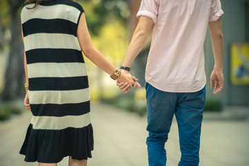 Valentine couples walk hand in hand and walk along the walkway 