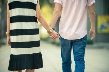 Valentine couples walk hand in hand and walk along the walkway 