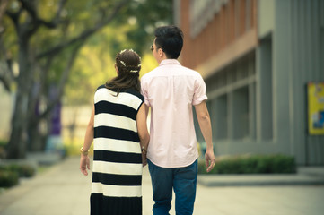 Valentine couples walk hand in hand and walk along the walkway 