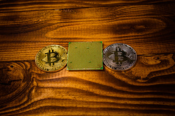 Bitcoins and microprocessor on a wooden table