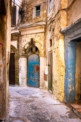 Fototapeta na wymiar The dilapidated buildings of a small street in the Mellah district in Essaouira, Morocco