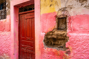 A pink wall and a precarious electrical installation in a street in the medina of Essaouira, Morocco