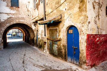 Fototapeta na wymiar In the former Jewish quarter of Mellah in Essaouira, Morocco, the doors of dilapidated buildings are condemned