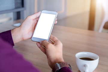 Mockup image of man's hands holding white mobile phone with blank screen technology and lifestyle concept.