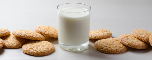 Milk in a glass Cup, sesame cookies. Horizontal photo. Space for copy