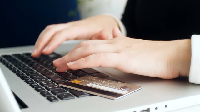 Closeup 4k footage of young woman doing online purchases with credit card