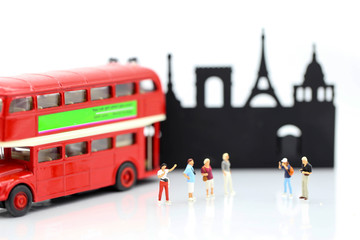Miniature people : traveling with friend and bus using for concept of Tourism day.