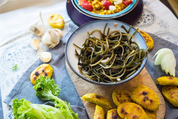 Chuka laminaria seaweed salad with lime, lemon juice, garlic, onion on plate. Traditional Japanese, Chinese, Korean asian seafood. Healthy vegan lunch