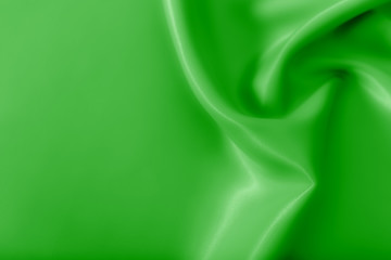Smooth elegant shiny green silk or satin luxury cloth texture can use as abstract holidays...
