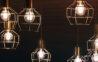 Fototapeta na wymiar Chandelier with hanging bulb lamps, yellow LED