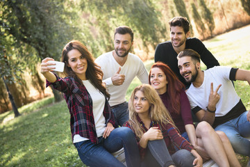 Group of friends taking selfie in urban background