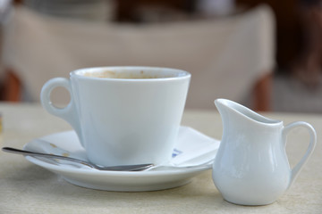 Wake-up time, cup of fresh hot coffee at table of restaurant