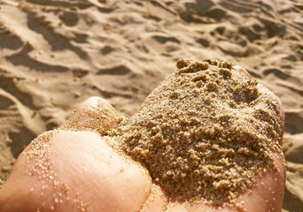 Beach sand in the hand, Mediteranean beach in Greece