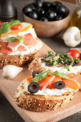 Italian tomato and cheese bruschetta. Tapas, antipasti with chopped vegetables, herbs and oil on grilled ciabatta and baguette bread.