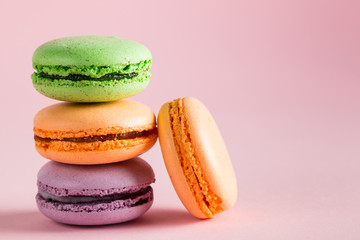 Still life and food photo of cake macarons in a gift box with flowers, a cup of tea on light background. Sweets and desserts concept of macaroons.