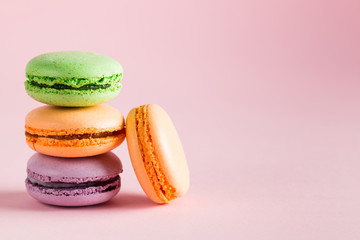 Still life and food photo of cake macarons in a gift box with flowers, a cup of tea on light background. Sweets and desserts concept of macaroons.