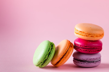Still life and food photo of cake macarons in a gift box with flowers, a cup of tea on light background. Sweets and desserts concept of macaroons.