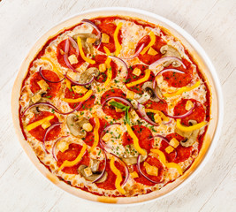 Pizza with salami and mushrooms