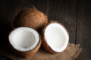 Ripe half cut coconut on a wooden background. Ripe half cut coconut on a wooden background. Coconut cream and oil.